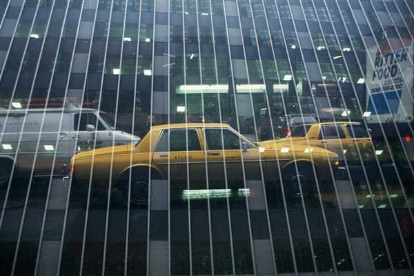 Reflection of Vehicles on Mirrored Building, Low Angle View