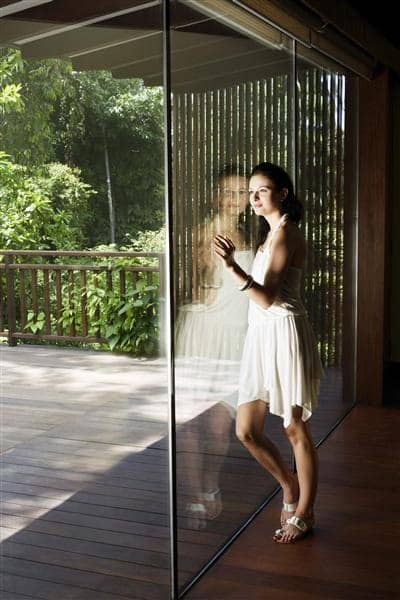 Woman Leaning on Glass Door