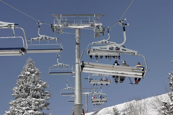 Skiers in a chairlift Skiers in a chairlift
